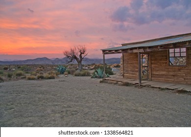 American Texan Landscape, Wooden House In The Far West At Sunset In The Desert