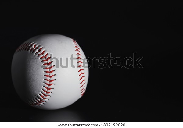 American traditional sports game. Baseball.\
Concept. Baseball ball and bats on a\
table.