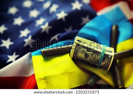 American and Ukrainian flags, a pack of American dollars. Aid lend-lease concept.