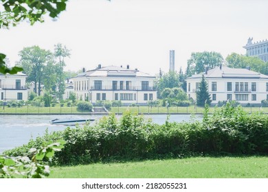 American Upper Middle Class Single Family Houses Neighborhood Street Along The River Surrounded By Park Or Forest. Modern Real Estate.