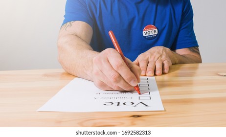 American voter marks his candidate on a paper ballot for US Presidential Elections.