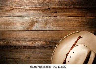 American West authentic white straw cowboy hat on old and aged western saloon floor wood plank background