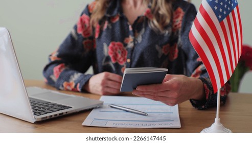 American woman consular officer giving passport to male immigrant, work visa, citizenship. Visa Application online form immigration concept. Visa approval. - Shutterstock ID 2266147445