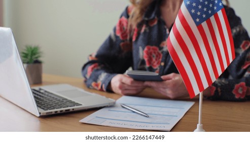 American woman consular officer giving passport to male immigrant, work visa, citizenship. Visa Application online form immigration concept. Visa approval. - Shutterstock ID 2266147449