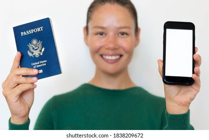 American Woman Holding A US Passport And A Phone With A Blank Screen.