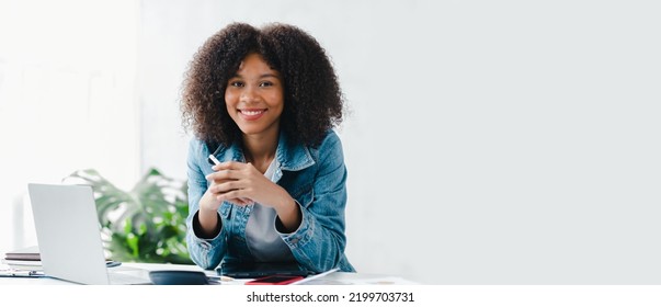 American woman sits in the white office of a startup company, she is a company employee, young generation operations run the company with the concept of the new generation. Company management concept - Shutterstock ID 2199703731