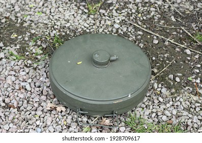 American World War Two Probably An M6A1 Anti Tank High Explosive Blast Mine At A Historic Reenactment Event On A Background Of Gravel Chips.