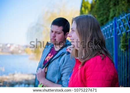 American young couple with overweight walk in park, man and woman together  