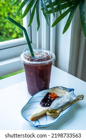 Americano Iced Coffee Or Black Coffee And Blueberry Cake On Wood Desk On Top View. As Breakfast In A Coffee Shop At The Cafe,during Business Work Concept