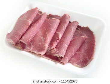 American-style corned beef on a supermarket or deli tray, with the slices folded back