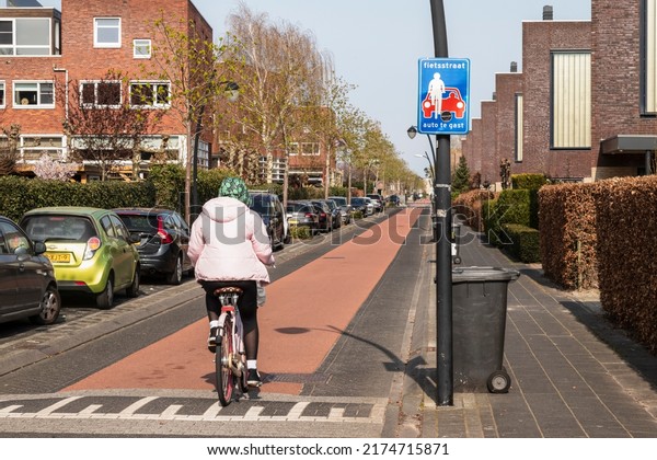 Amersfoort, The Netherlands, April 16, 2021;\
Cycle path through a residential area with a traffic sign  with the\
text; bike path, cars are\
guests.