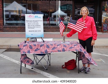 AMES, IA -25 MAY 2016- A Woman Encouraging People To Register To Vote On The Main Street In The Historic Downtown Of Ames, Iowa. 