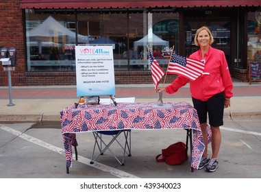 AMES, IA -25 MAY 2016- A Woman Encouraging People To Register To Vote On The Main Street In The Historic Downtown Of Ames, Iowa. 