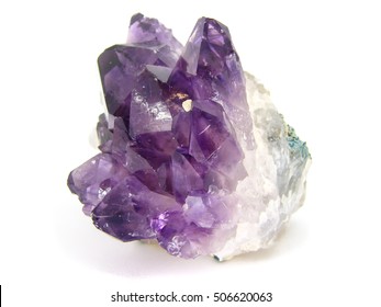 Amethyst crystal cluster on matrix isolated on white background