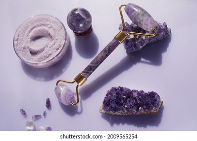 Amethyst Crystals Gua Sha Roller Massage Scraper And Beauty Product. Moisturizer And Skincare Tools. Wellness Concept.