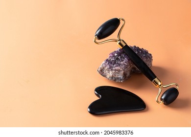 Amethyst Gua Sha Tool, Stone Roller On  On Beige Background For Holistic Beauty And Skin Care