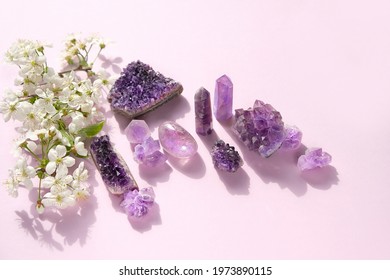 amethyst minerals set and white flowers. gemstones for esoteric spiritual practice, Healing Crystal Ritual, Witchcraft, Relax Chakra. Feng Shui, reiki therapy concept. top view