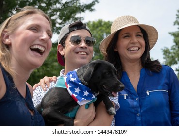 Amherst, N.H./USA - July 4, 2019: U.S. Rep. Tulsi Gabbard Poses With Voters And A Puppy During The Amherst July 4th Parade. 