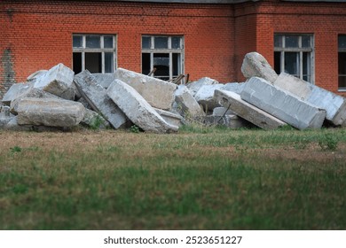 Amidst the remnants of urban decay, massive concrete blocks stand as silent sentinels, embodying the passage of time and the weight of forgotten stories surrounding the abandoned structure - Powered by Shutterstock