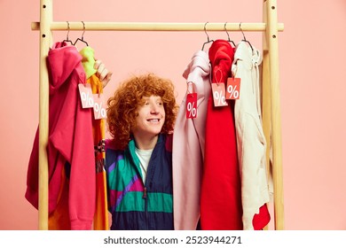 Amidst vibrant array of sale-tagged outfits, happy shopper beams with excitement, making most of markdowns on stylish finds. Concept of Black Friday, Cyber Monday, fashion, Flash Sale. Ad - Powered by Shutterstock