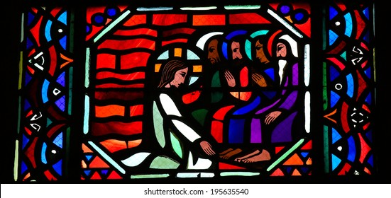 AMIENS, FRANCE - FEBRUARY 9, 2013: Stained glass window depicting Jesus washing the feet of the apostle Peter at the Last Supper on Maundy Thrusday, in the Cathedral of Our Lady of Amiens, France.