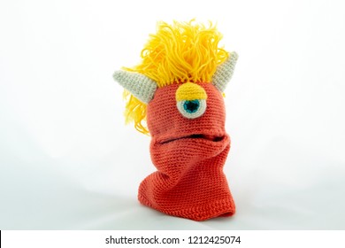 amigurumi crochet punk hand puppet monster, isolated on white