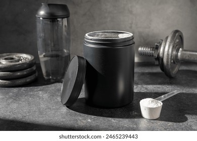 Amino acid food supplement, creatine powder in a measuring scoop and plastic jar - Powered by Shutterstock