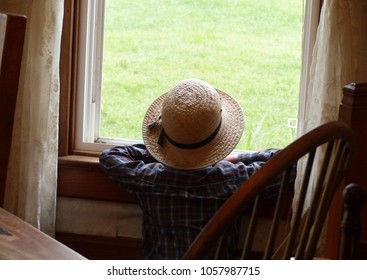 Amish Boy Looking Out House Window