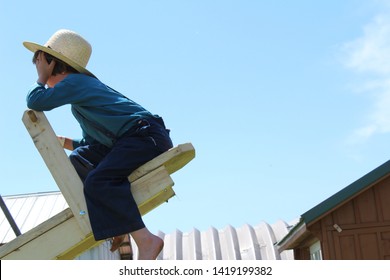 Amish Boy On A Wooden Teeter Totter