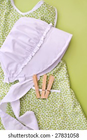 Amish Child's Bonnet And Apron With Clothes Pins.