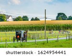 Amish country field agriculture, horse, harvest, farm, barn in Lancaster, PA US.