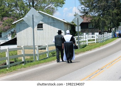 An Amish Couple Walks Home From Sunday Church Service In Rural Ohio.