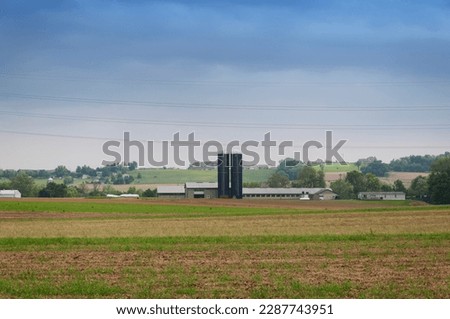 an amish farm and open field in the town of intercourse pennsylvania on an overcast day.