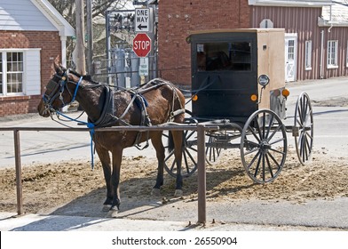 Amish Horse And Buggy Hitched To A Post In A Modern Community