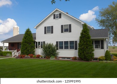 Amish House With Nice Green Grass And Flowers