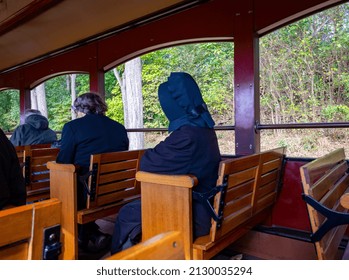 Amish People Taking A Train Ride In An Open Air Car On A Sunny Fall Day