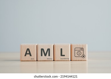 AML - Anti Money Laundering concept. Financial Bank Business. Against Illegal Earnings and corruption. Wooden block with AML text and dollar coin in washing machine. - Shutterstock ID 2194144121
