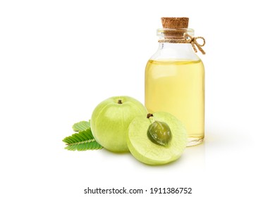 Amla (Indian gooseberry) oil with fruits and leaf isolated on white background.