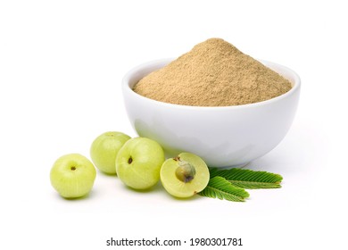 Amla (Indian gooseberry) powder with fresh fruits on white background.