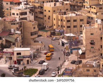 Amman, Jordan, February 2020: Close up view of Amman busy downtown streets and traffic with two orange public buses from the Citadel, downtown  and skyline of the city.