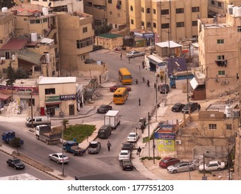 Amman, Jordan, February 2020: Close up view of Amman busy downtown streets and traffic with two orange public buses from the Citadel, downtown  and skyline of the city.