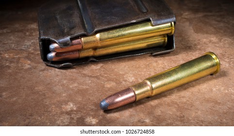 Ammunition for a 303 rifle and magazine on a beige background