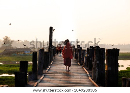a among is walking on U-beng bridge Mandalay Myanmar in the morning.