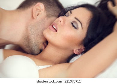 amorous couple making love in bed