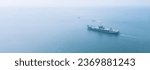 Amphibious Assault Ship. Navy aircraft carrier Aerial top view of battleship, Military sea transport, Military Navy Rescue Helicopter on board the battleship deck