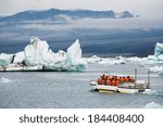 An amphibious vehicle taking tourists for a cruise around the icebergs in the Jokulsarlon glacier lake, where huge chunks of ice from the Vatnajokull glacier float out to the Atlantic ocean 