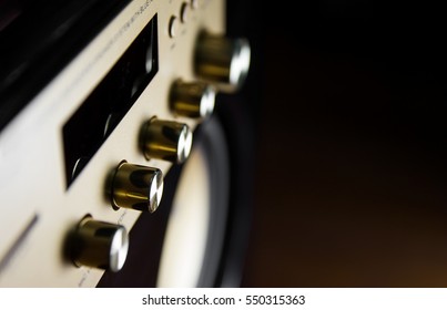 Amplifier button control of audio system for music background style in dark tone and select focus.
