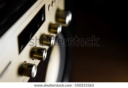 Amplifier button control of audio system for music background style in dark tone and select focus.