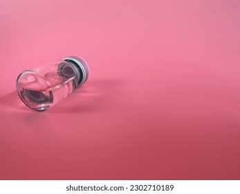 Ampoule, mesotherapy cocktail, vaccine, for aesthetic medicine treatments lying on pink background. Overturned vial. Medical accessory, medicine bottle - Shutterstock ID 2302710189
