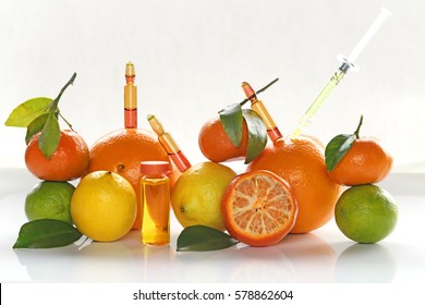 ampoules and Serum with Vitamin C. Organic cosmetics concept. Lemon, lime, orange, tangerine and cosmetic ampoules 